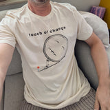 Person wearing a white t-shirt with 'touch of change' design sitting on a couch.
